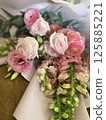 There is a bouquet of pink roses 125885221