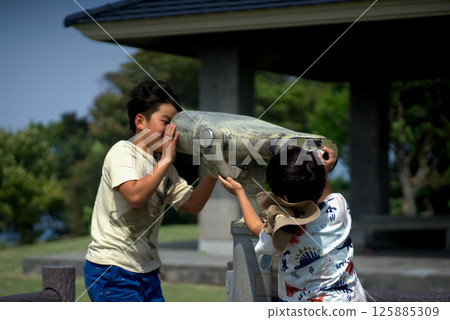 <People> Brothers playing with binoculars on a mountain observation deck <People> Brothers playing with binoculars on a mountain observation deck 125885309