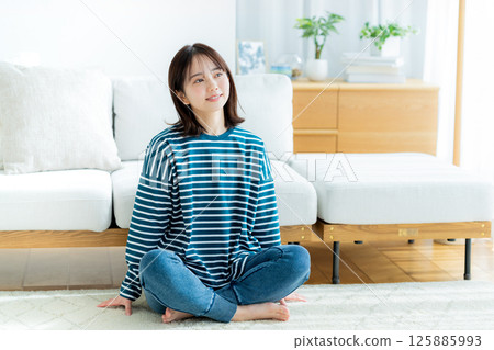 Young woman relaxing in the living room Young woman relaxing in the living room 125885993