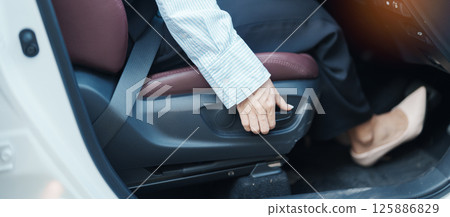 Business woman hand adjust car seat before drive on the road. Ergonomic, health  care and safety transportation concept 125886829