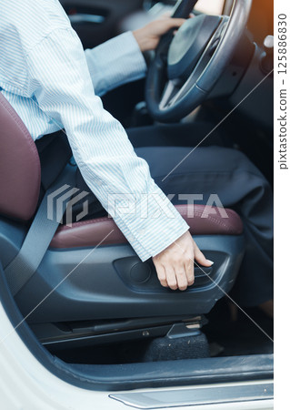 Business woman hand adjust car seat before drive on the road. Ergonomic, health  care and safety transportation concept 125886830