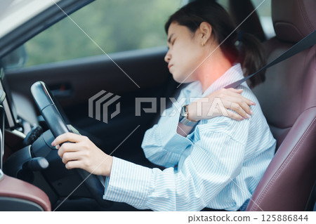 woman with her shoulder and neck sprain while driving car long time, muscle painful. Shoulder ache, Scapular pain, office syndrome and ergonomic concept woman with her shoulder and neck sprain while driving car long time, muscle painful. Shoulder ache, Scapular pain, office syndrome and ergonomic concept 125886844