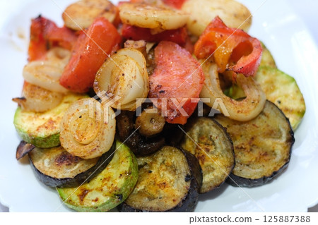 Vegan cuisine: Grilled mixed vegetables on a wooden cutting board 125887388