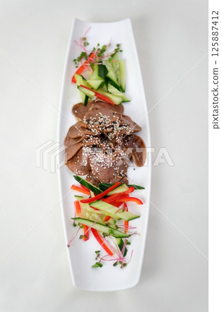 Food tray with delicious salami, ham, fresh sausages and herbs. Meat platter with selection. 125887412