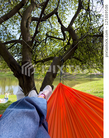 Relaxing in Hammocks by the Lake 125889586