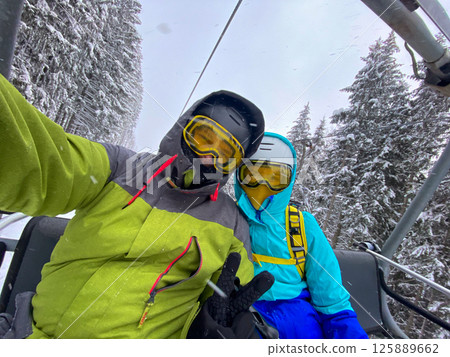 Skiers Taking Selfie on Snowy Mountain 125889662