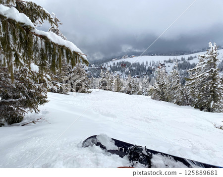 Snowboard on Snowy Mountain Slope 125889681