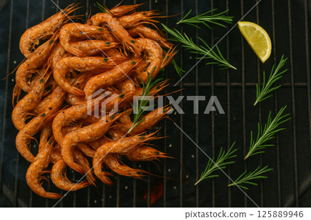 Grilled tiny shrimps on charcoal with rosemary 125889946