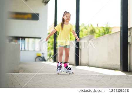 Active child riding roller-blades outside having fun Active child riding roller-blades outside having fun 125889958