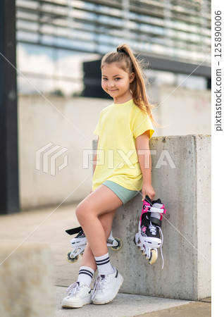 Young female skater having fun rollerblading in stadium Young female skater having fun rollerblading in stadium 125890006