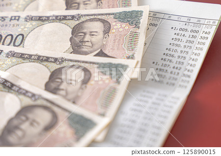 Money and passbook 125890015