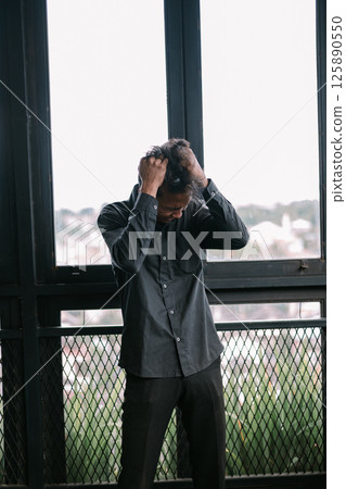 composite image of stressed businessman with hands on head 125890550