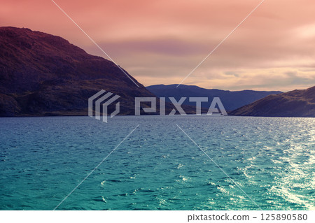 Seascape in the evening. View of the fjord. Rocky sea shore during sunset. Beautiful nature of Norway. Seascape in the evening. View of the fjord. Rocky sea shore during sunset. Beautiful nature of Norway. 125890580