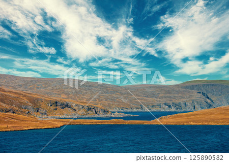 View of the fjord and beautiful sky. Beautiful nature of Norway. Arctic bay. Mageroya island. Nordkapp. 125890582