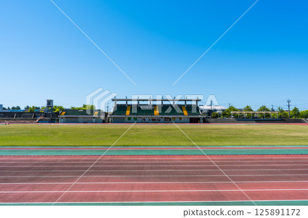 Image of a clear blue sky and the track at the athletics stadium | Suehiro Athletics Stadium (also known as Kanjincho Stadium) | Komatsu City, Ishikawa Prefecture Image of a clear blue sky and the track at the athletics stadium | Suehiro Athletics Stadium (also known as Kanjincho Stadium) | Komatsu City, Ishikawa Prefecture 125891172