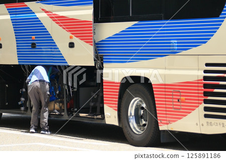 Loading luggage onto express buses 125891186