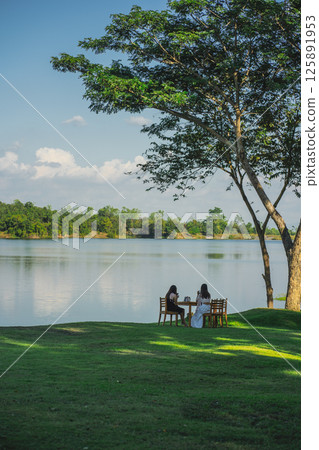 travel and people activity concept with camping on grass  with mountain and lake on foreground 125891953