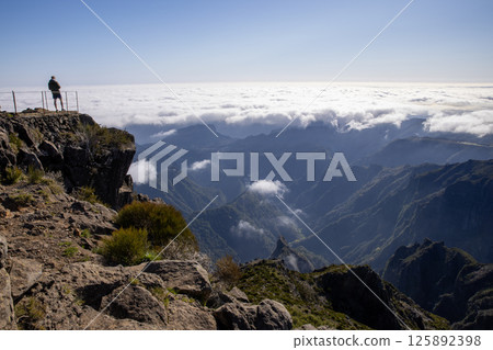 Epic View on mountain peaks with clouds rolling in the valley in Madeira Epic View on mountain peaks with clouds rolling in the valley in Madeira 125892398