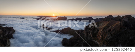 Epic Sunset View in High Mountain Landscape in Madeira Island . Clouds in the Valley . 125892440