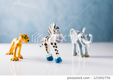 Funny plastic toys: zebra, leopard and elephant. Plastic figures of safari animals. 125892756