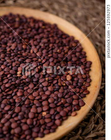 Organic uncooked seeds dark red brown lentils. Organic uncooked seeds dark red brown lentils. 125892973