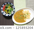 Chicken curry with carrot rice and black bean salad 125893204