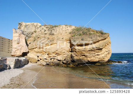 Beautiful landscape of the Black Sea. The natural coastline of the Odessa Bay consists of shell rock and clay against which the sea waves break. 125893428