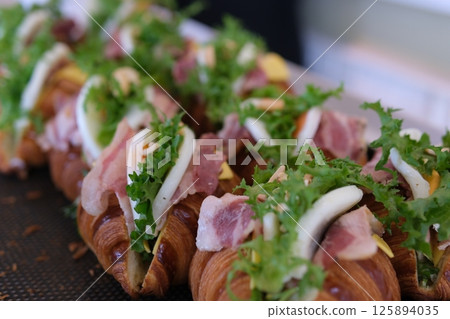 Croissants meat greens stacks of croissant sandwich at wedding 125894035