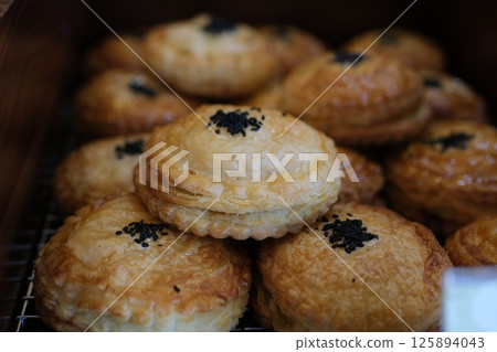 puff pastry round buns Turkish little pogaca. traditional flavors. Pogaca on wooden background 125894043