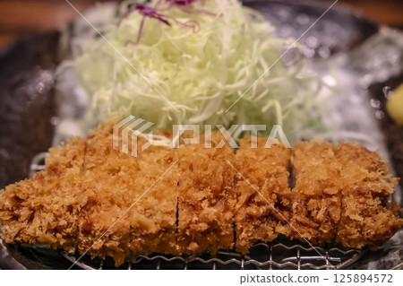 Crispy Fried Pork Cutlet Served With Cabbage Salad 125894572