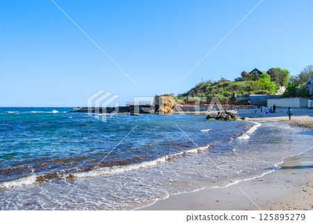 Beautiful landscape of the Black Sea. The natural coastline of the Odessa Bay consists of shell rock and clay against which the sea waves break. Beautiful landscape of the Black Sea. The natural coastline of the Odessa Bay consists of shell rock and clay against which the sea waves break. 125895279