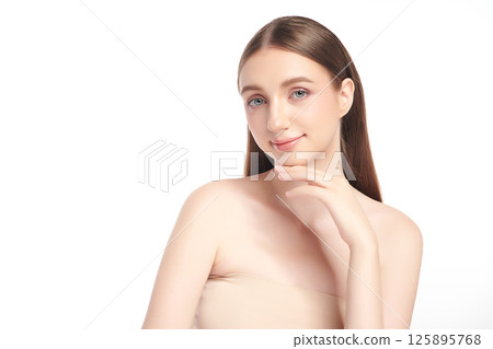 A beautiful young woman with clean, fresh skin against a white background. Skincare, facial treatment, cosmetology, beauty, and spa. An elegant portrait of an woman. 125895768