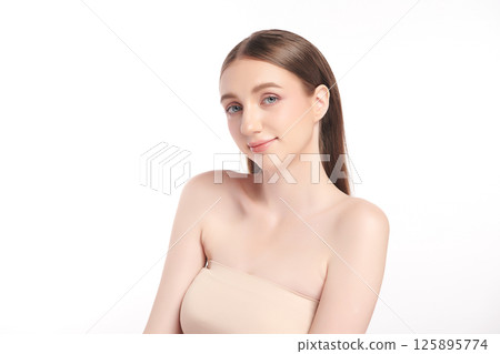 A beautiful young woman with clean, fresh skin against a white background. Skincare, facial treatment, cosmetology, beauty, and spa. An elegant portrait of an woman. A beautiful young woman with clean, fresh skin against a white background. Skincare, facial treatment, cosmetology, beauty, and spa. An elegant portrait of an woman. 125895774