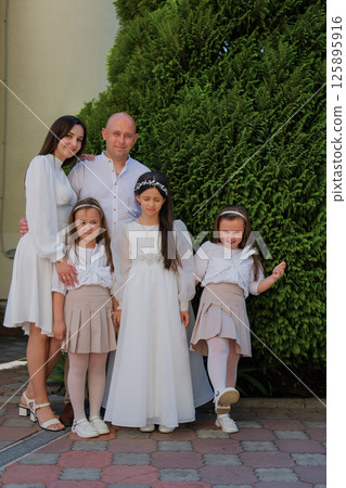 The family is waiting for an important moment related to the First Communion. The family is waiting for an important moment related to the First Communion. 125895916