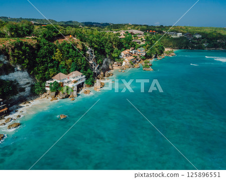 Above view of ocean and cliff coastline with hotels on Impossibles beach in Bali 125896551
