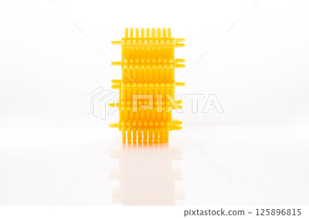 The children's construction set is presented in the form of yellow blocks arranged on a bright background. Playing with such details arouses interest in modeling. The children's construction set is presented in the form of yellow blocks arranged on a bright background. Playing with such details arouses interest in modeling. 125896815