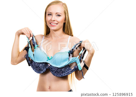 Woman holds bras, choosing 125896915