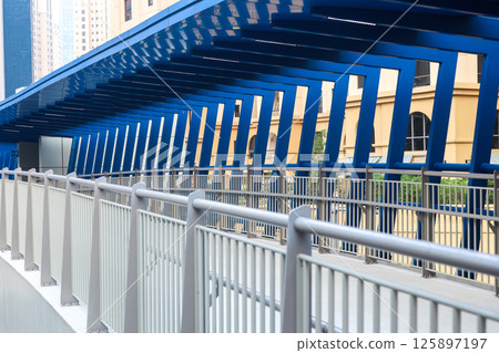 Modern futuristic overpass over the roadway in the city center 125897197