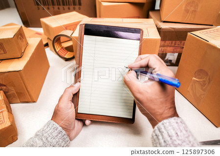 Seller Checking Packing boxes Seller Checking Packing boxes 125897306
