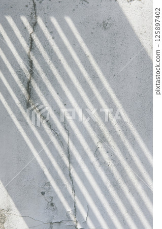 Soft light and shadows on simple textured walls. 125897402