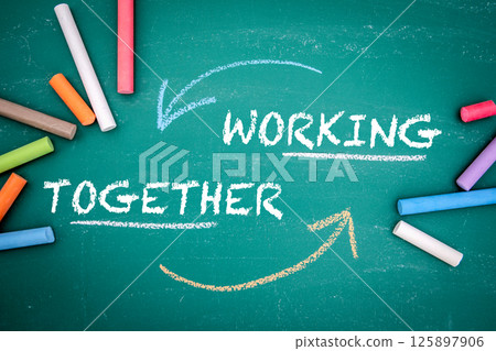 Working Together Concept with Arrows and Colored Chalk on Chalkboard Working Together Concept with Arrows and Colored Chalk on Chalkboard 125897906