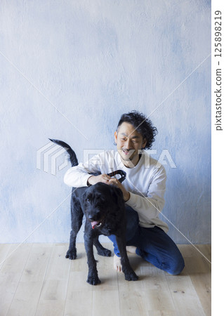 Man relaxing with his dog Man relaxing with his dog 125898219