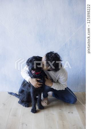 Man relaxing with his dog 125898222