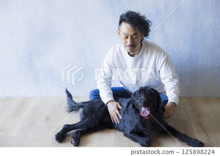 Man relaxing with his dog 125898224