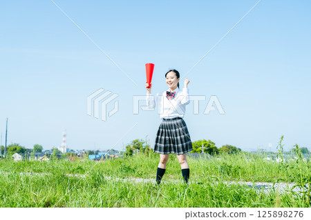 High school students cheering with megaphones 125898276
