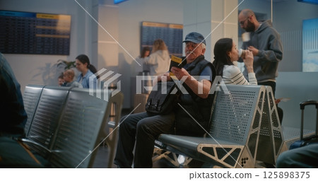 Airport Terminal: Multiethnic People Waiting for Airplane Flight in Departure Lounge of Airline Hub Airport Terminal: Multiethnic People Waiting for Airplane Flight in Departure Lounge of Airline Hub 125898375