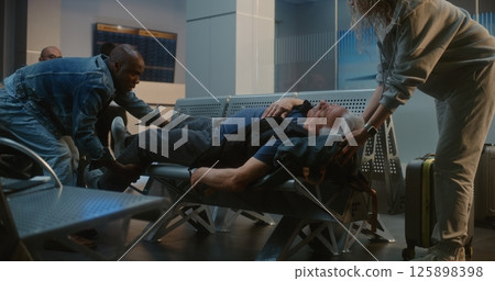 Airport Terminal: Elderly Man Having Heart Attack, Infarction. Airport Worker Calling for Medical Help 125898398