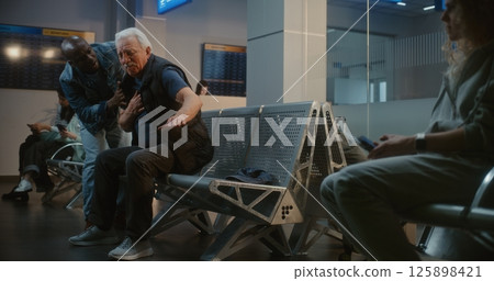 Airport Terminal: Senior Man Having Heart Attack. Diverse People Helping, Calling for Medical Help 125898421