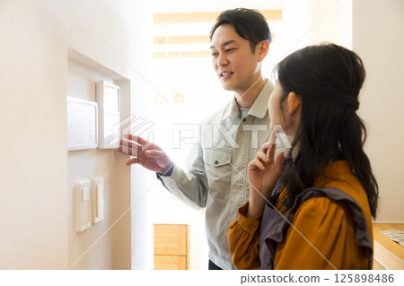 Handing over a house: A man in work clothes doing after-maintenance 125898486