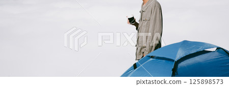 Man traveler with backpack hiking outdoor travel lifestyle and adventure concept. join of tourist for green mountain tour beauty of nature and expansive sky people of tourism. banner with copy space Man traveler with backpack hiking outdoor travel lifestyle and adventure concept. join of tourist for green mountain tour beauty of nature and expansive sky people of tourism. banner with copy space 125898573